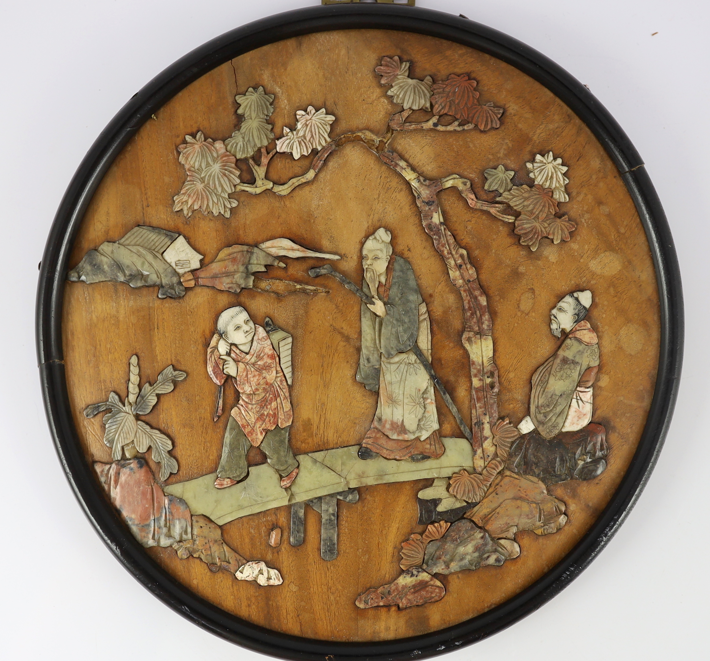 A Chinese wood and soapstone inlaid circular screen panel, late Qing dynasty